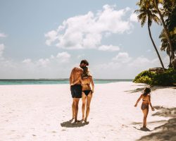 Romantic couple on beach holiday with kid